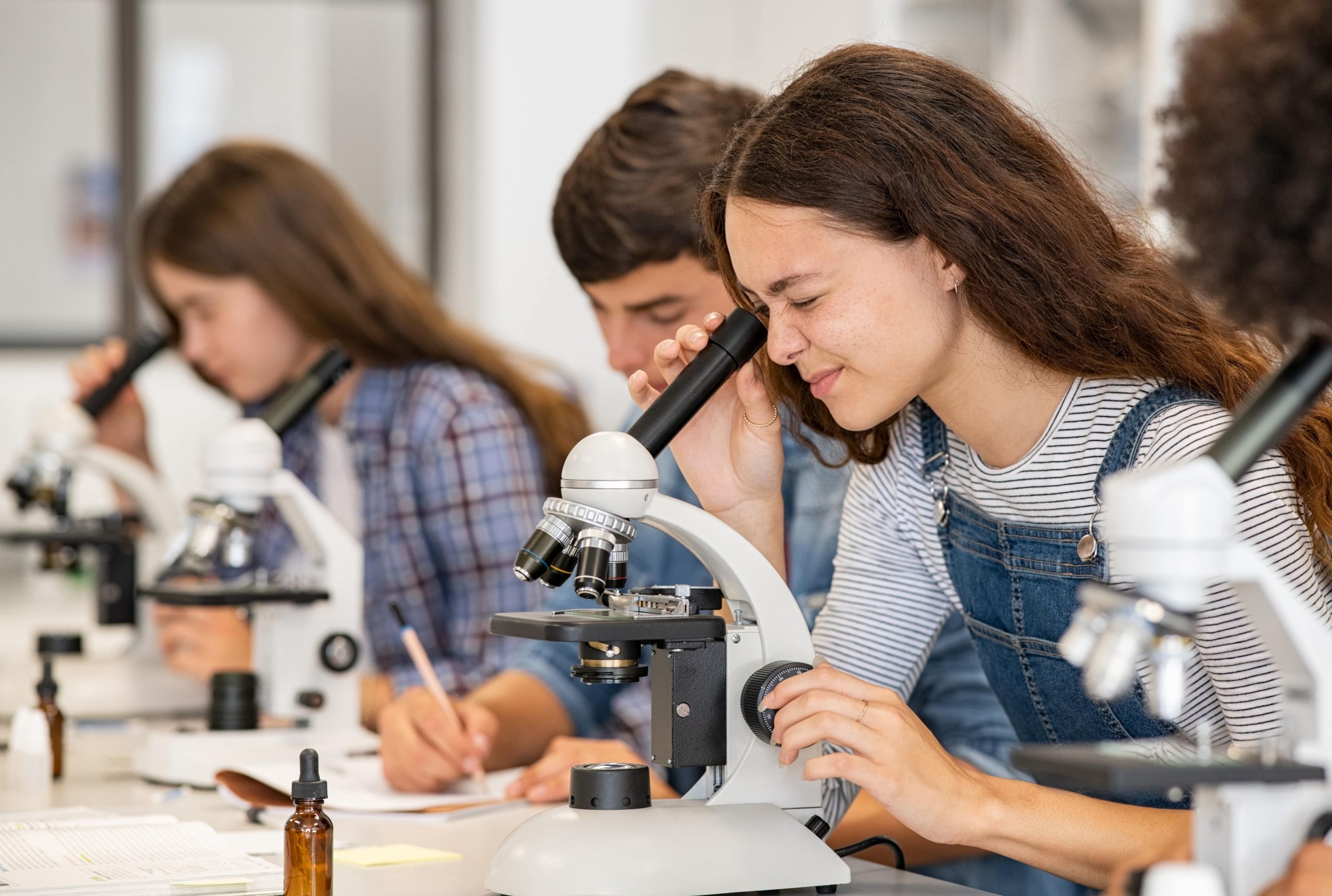 Люди которые становятся учеными. Студент биолог. Студенты в лаборатории. Студентка с микроскопом. Микроскоп в лаборатории студенты.