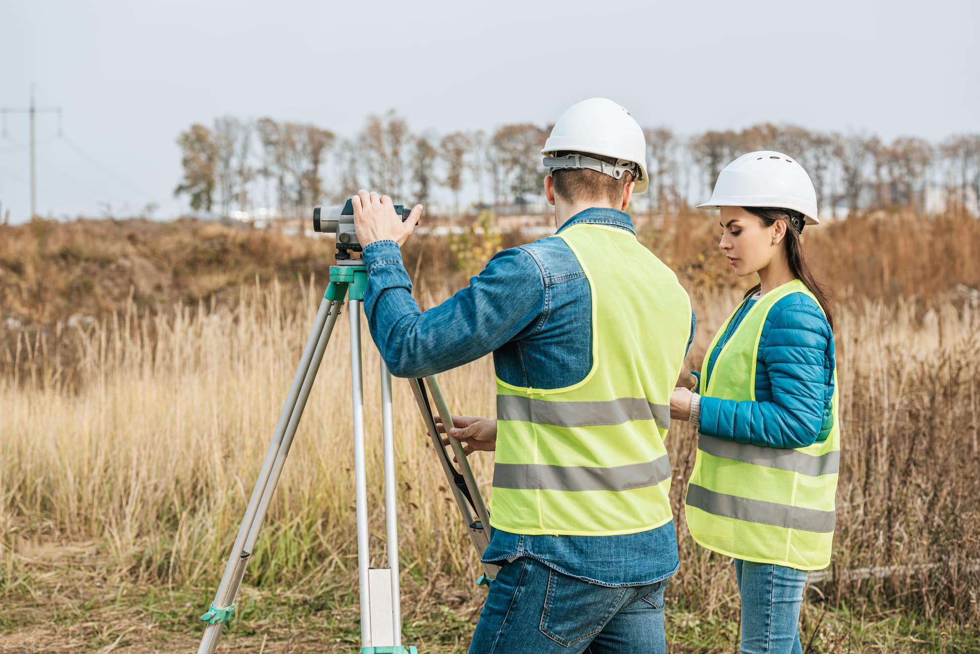 surveyors-working-with-digital-level-in-field-2021-09-22-01-08-11-utc