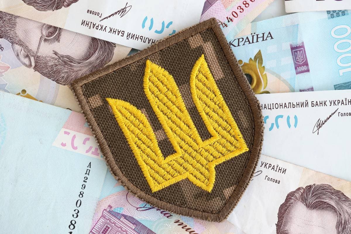 ukrainian-military-symbol-and-hryvnia-bills-payme-2023-12-21-20-52-09-utc (1) (1)
