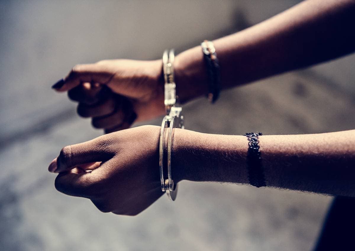 closeup-of-arrested-hands-with-handcuffs-2023-11-27-05-19-49-utc (1) (1)