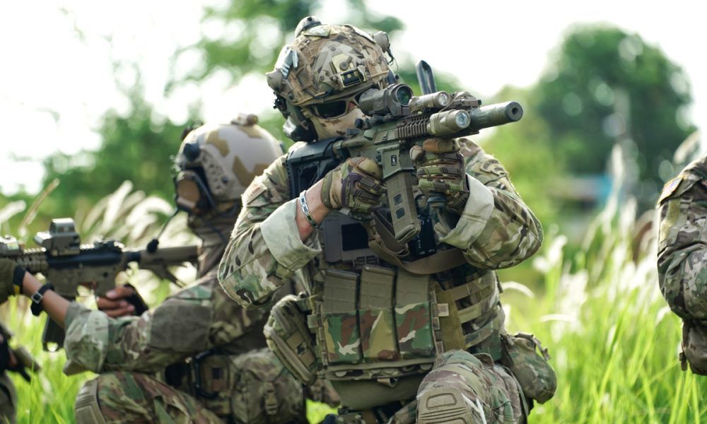 Infantry soldier shooting during military combat training.