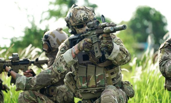 Infantry soldier shooting during military combat training.