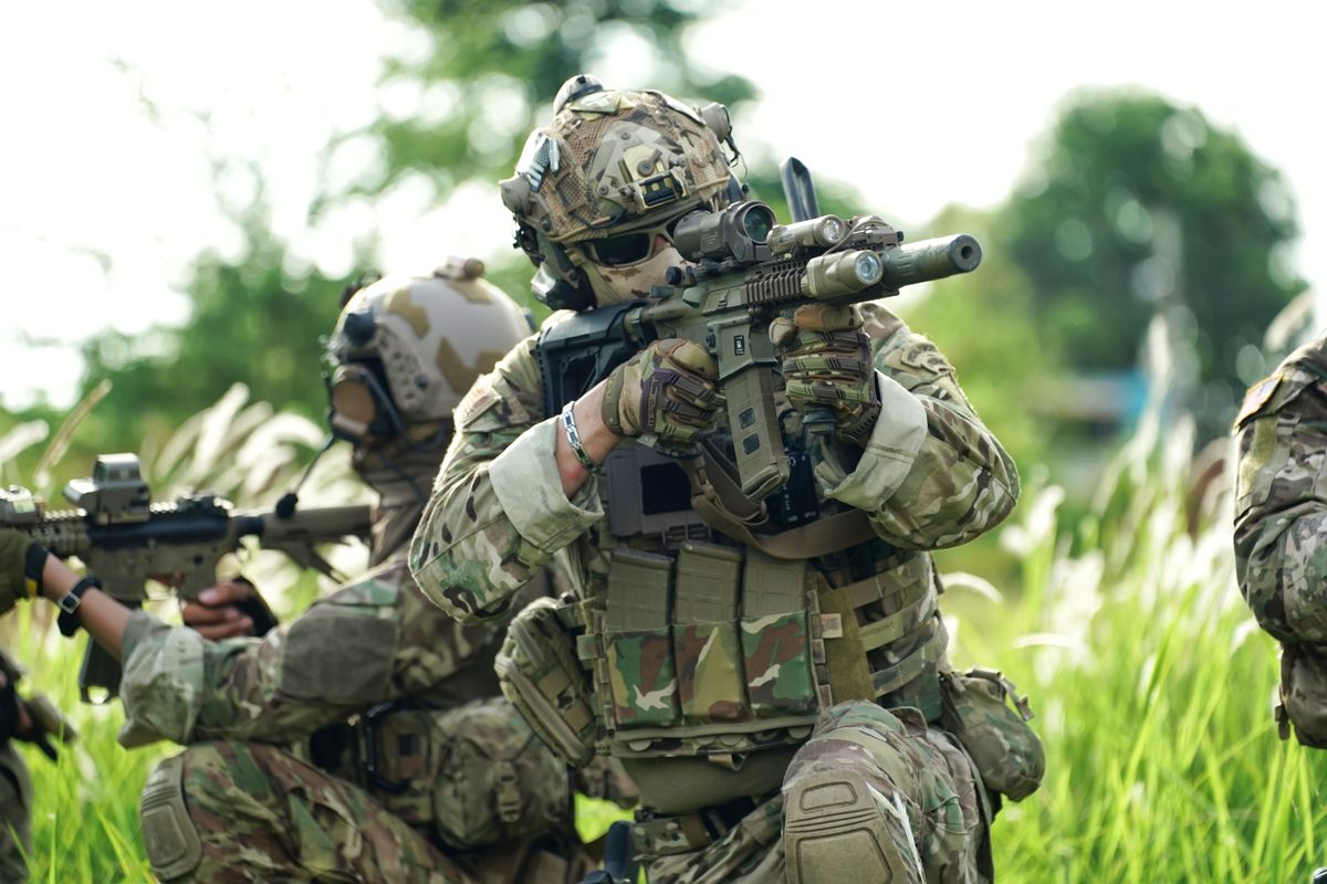Infantry soldier shooting during military combat training.